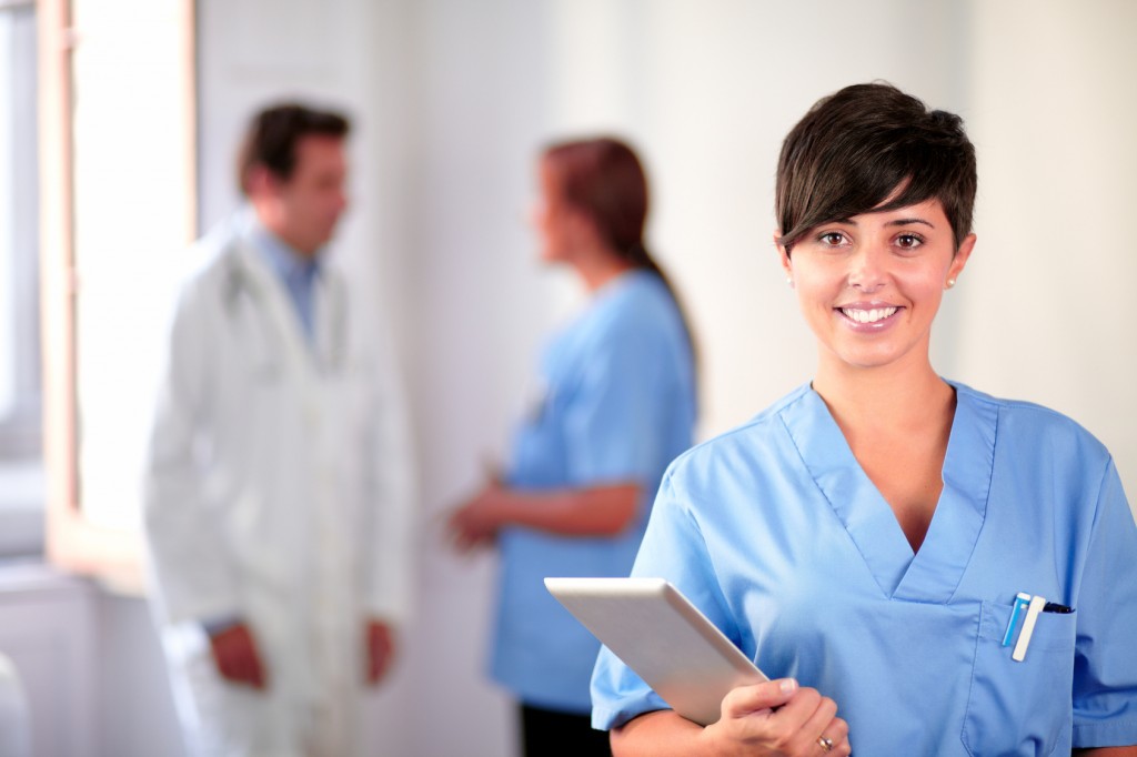 Lovely latin nurse on blue uniform standing