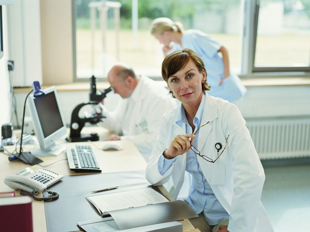 Female doctor sitting in office, portrait