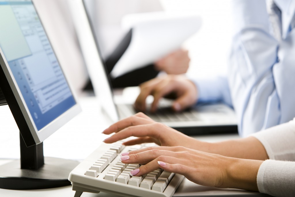 Female hands typing a letter on the keyboard